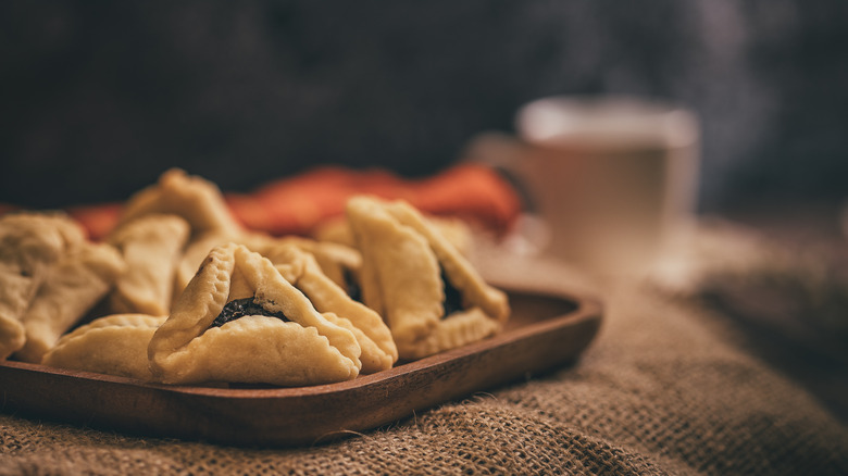 Hamantaschen cookies on brown board