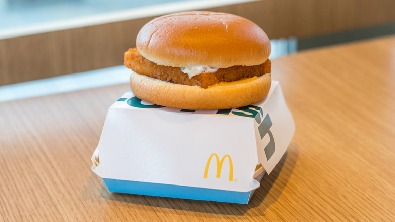 McDonald's Filet-O-Fish burger on top of blue and white clamshell box.