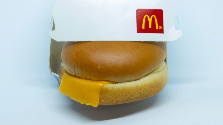 Filet-O-Fish sandwich sticking out of box with half-slice of cheese visible.