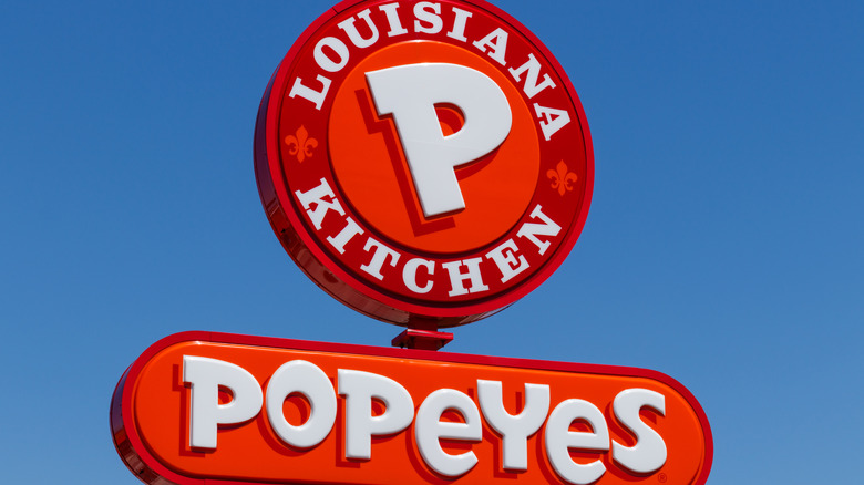 Popeyes restaurant sign, blue sky