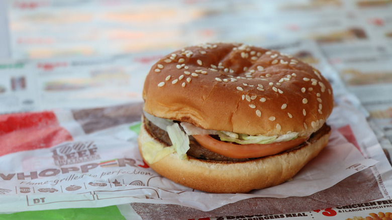 A Whopper Jr. sits on top of burger wrappers