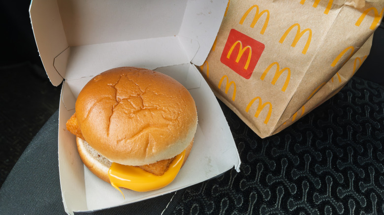 An opened box of Fillet-O-Fish with a McDonald's paper bag behind it