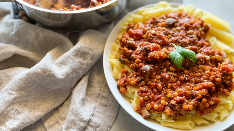 plate of pasta with lentil bolognese on kitchen towel