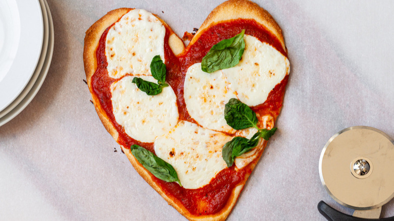 heart-shaped pizza on table 