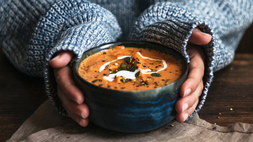 woman holding bowl of soup