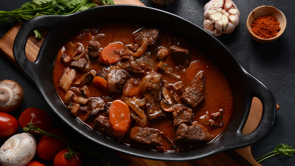 beef bourguignon with carrots and mushrooms in a pot