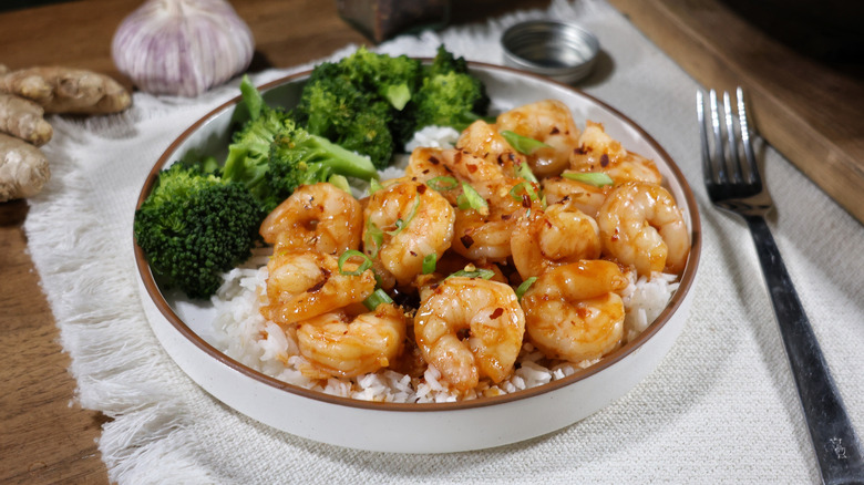 plate of shrimp with spicy honey garlic sauce, rice, and steamed broccoli