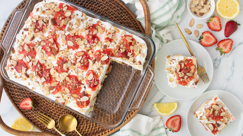 Strawberry heaven on earth cake in baking dish next to slices on plates