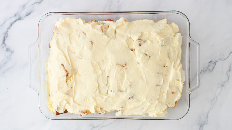 Pudding spread over cake in baking dish