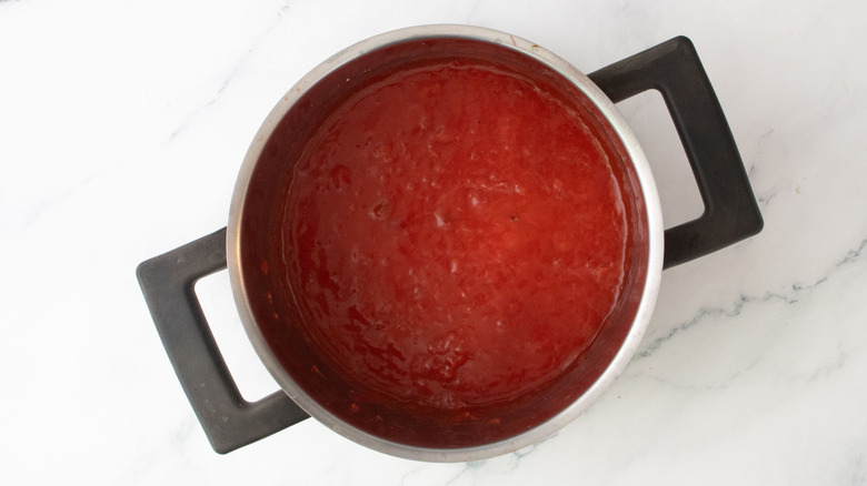 Mashed strawberries in pot