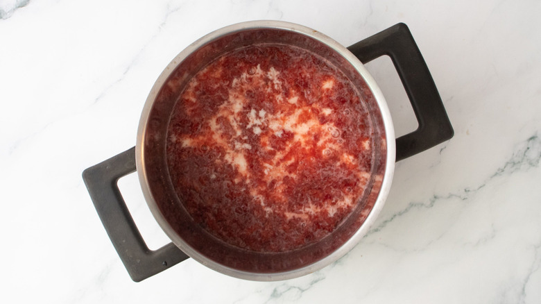 Mashed strawberries with cornstarch slurry in pot