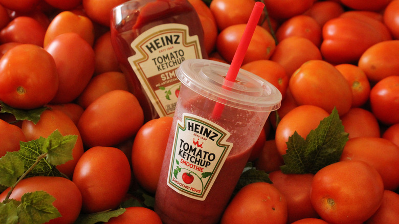 Tomato Ketchup Smoothie on a bed of small tomatoes with a bottle of ketchup
