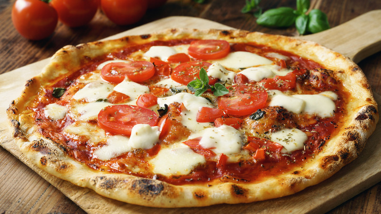 Margherita pizza on wooden paddle