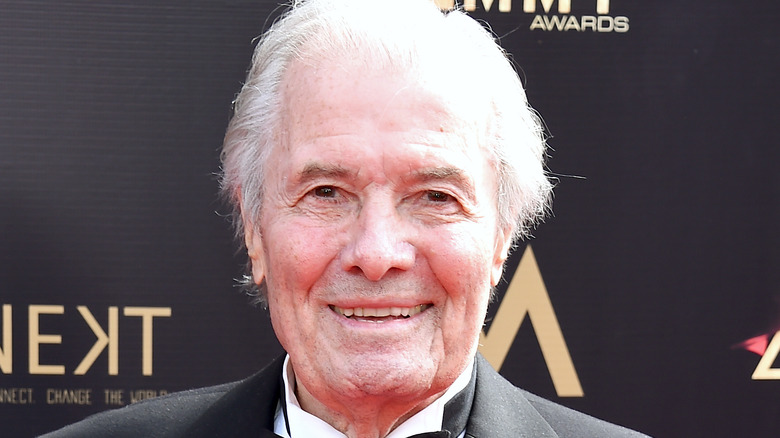 Jacques Pépin smiles in a black suit