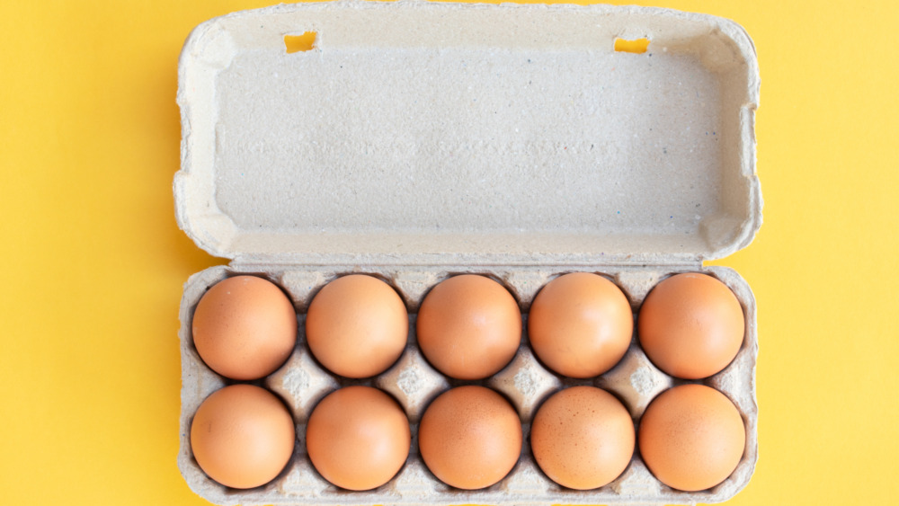 Dozen brown eggs in a white carton