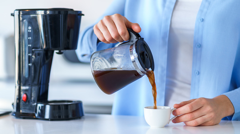 Person pouring cup of coffee