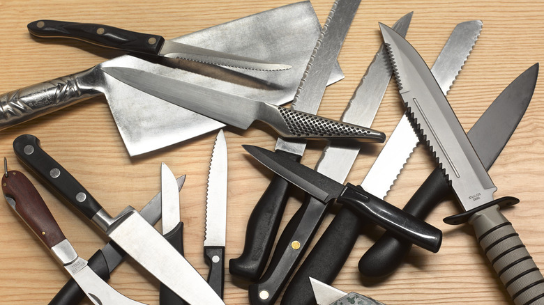 Kitchen knives on wooden surface