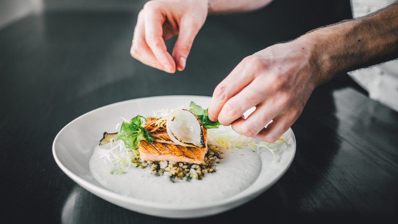 Chef hands perfecting dish