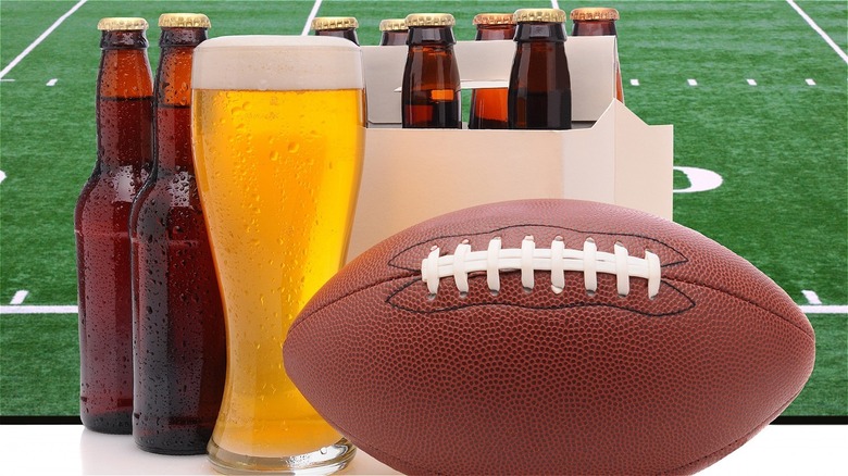 Beer in a glass and bottles with a football