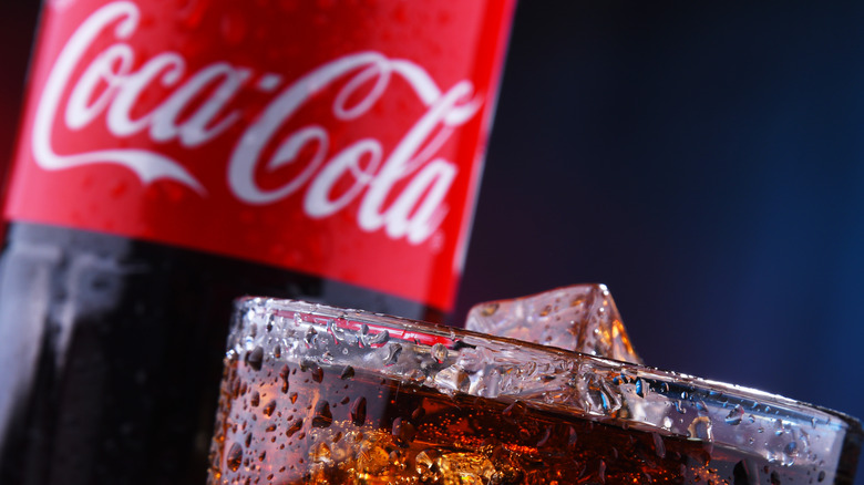 Coca-cola bottle and glass with ice