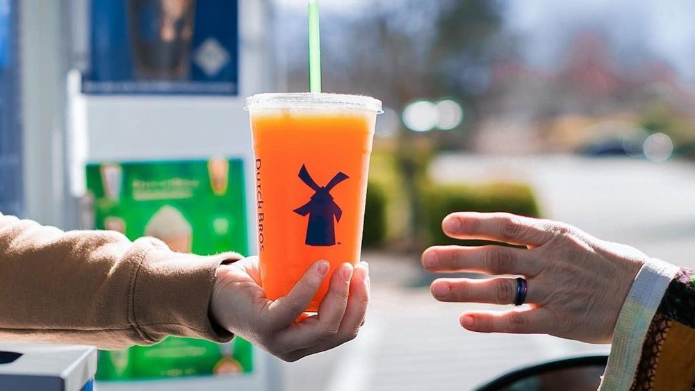 Dutch Bros employee handing drink over