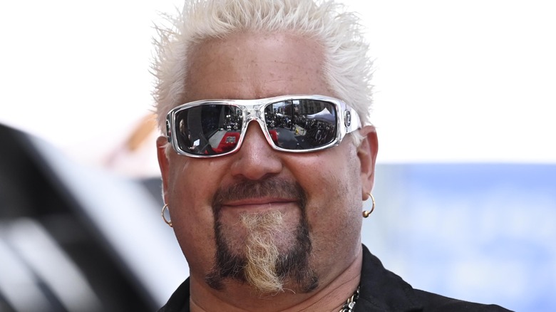 Guy Fieri smiling with sunglasses on