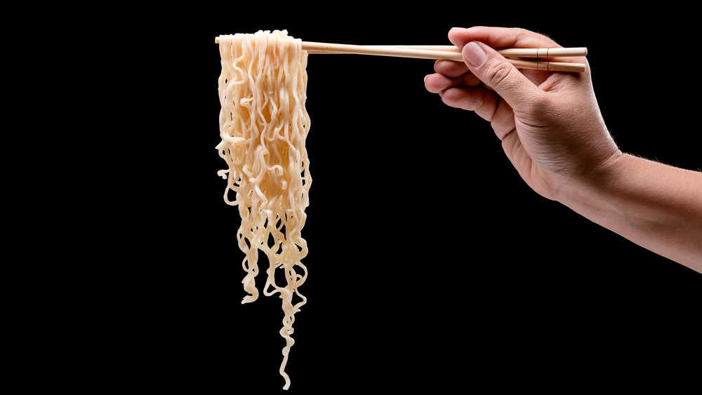 Holding ramen noodles on chopsticks