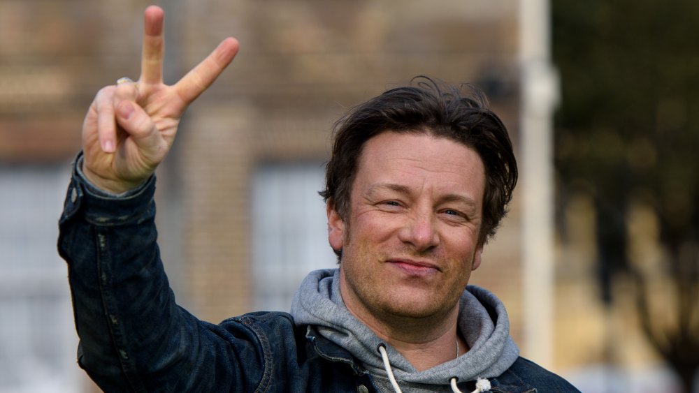 Jamie Oliver flashes a peace sign