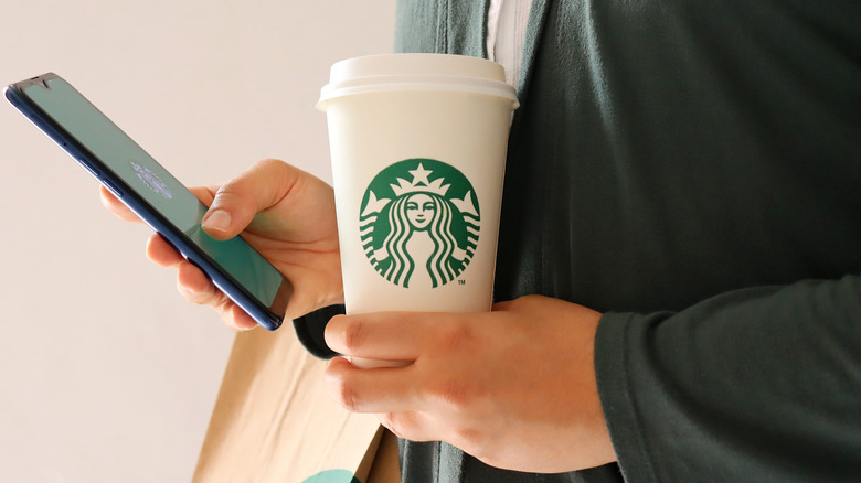 Starbucks customer checking phone