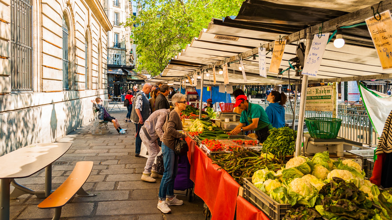 Traditional food market in Paris during sunny morning