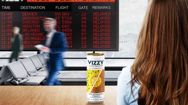 Hard seltzer in front of flight schedule