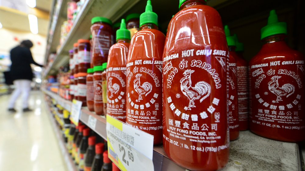 Rows of Sriracha bottles on sale