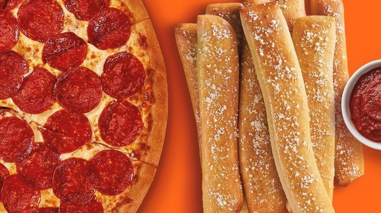 A side by side of Little Caesar's pizza and crazy bread