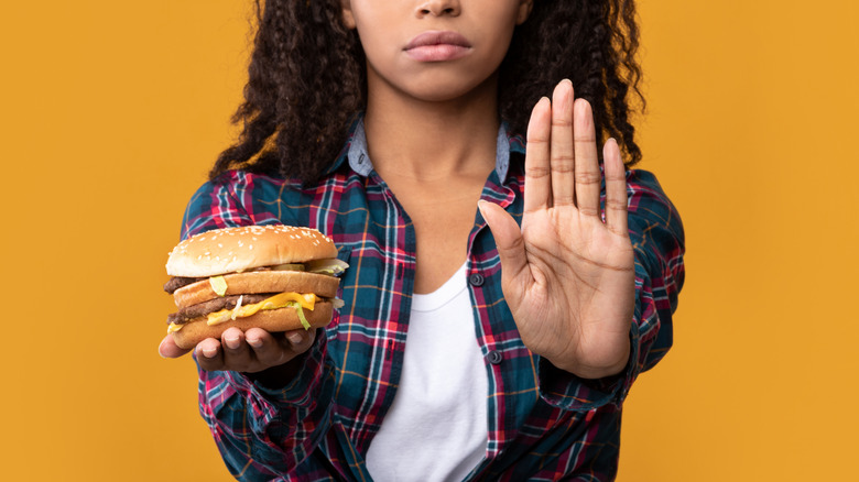 Woman holding bad burger