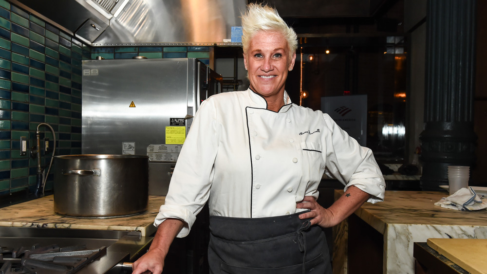 Anne Burrell standing a kitchen