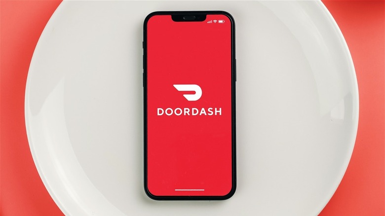 Phone with DoorDash logo on dinner plate