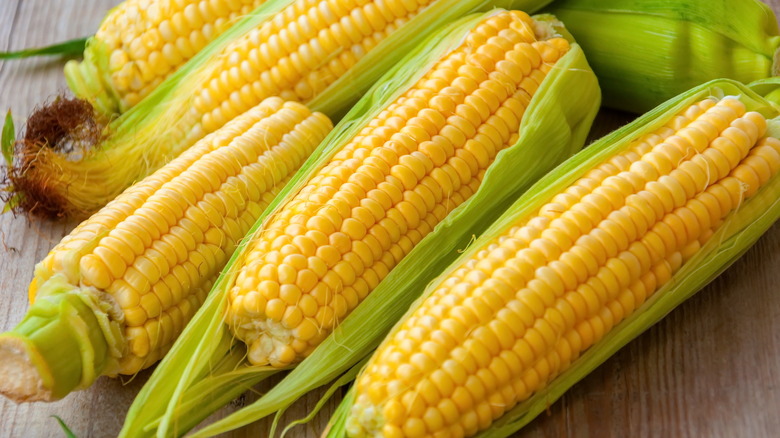 Corn on the cob on wooden surface