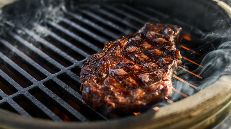 Steak grilling on a grate