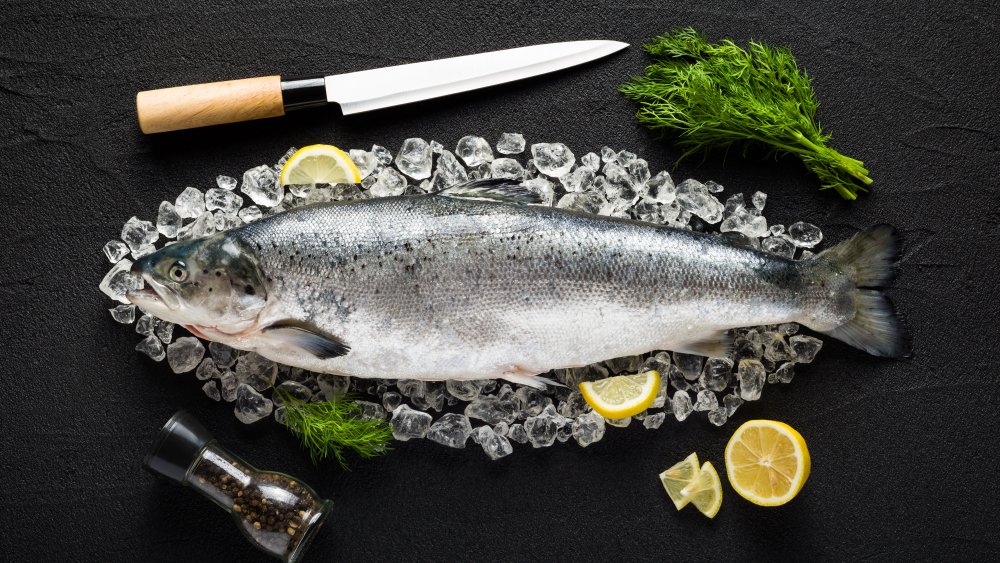 Fish on ice with a knife