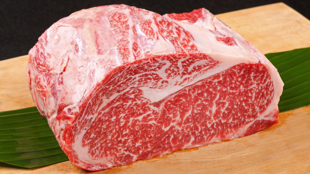 A cut of wagyu beef on a wooden board 