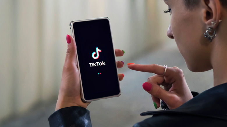 Woman checking the Tik Tok app on the phone