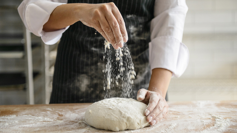 hands kneading bread dough