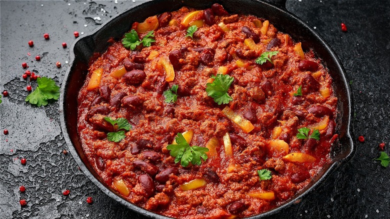 cast iron pan with tomato-based dish