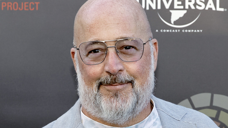 andrew zimmern smiling with glasses