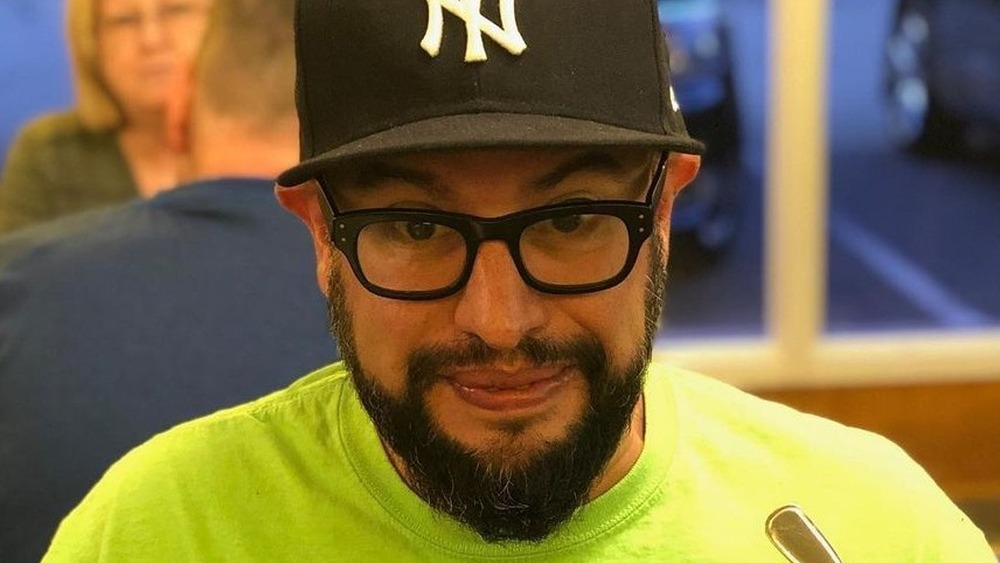 Carl Ruiz in hat and glasses