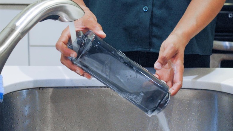 Person washing Clean Bottle