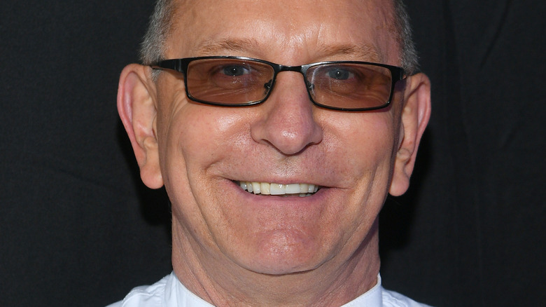 Robert Irvine smiling in tinted glasses