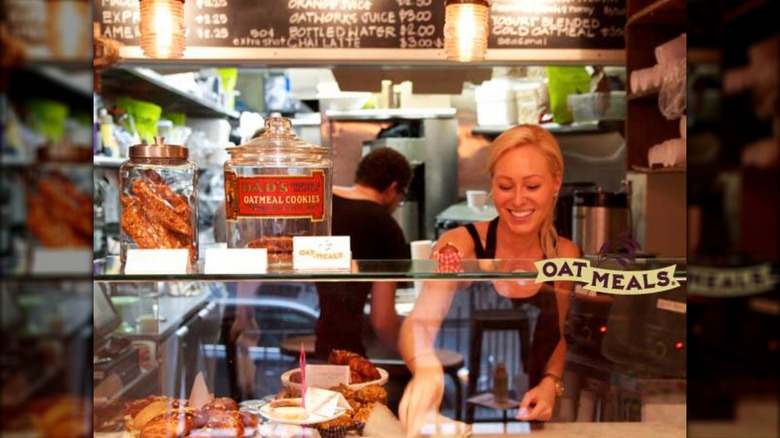 Woman standing in window at OatMeals shop