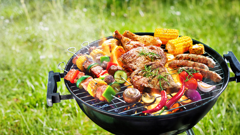 Various meats and vegetables on a grill