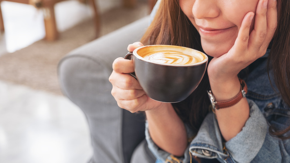 Closeup of woman drinking coffee